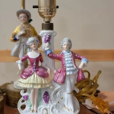 Vintage porcelain small table lamp featuring a hand-painted courtly gentleman and lady figurine with gilded accents.