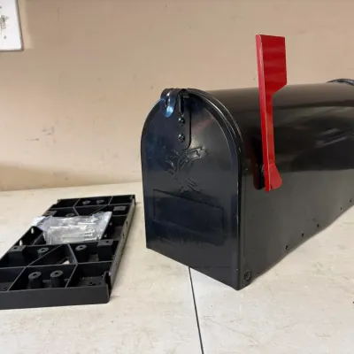 Black Metal Rural Mailbox with Red Flag and Mounting Base