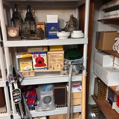 Sale Photo Thumbnail #33: Assorted household goods, including small appliances, vacuums, lighting fixtures, decorative items, and boxed decor.