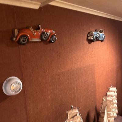 Sale Photo Thumbnail #64: Vintage molded plastic vintage automobile wall art plaques paired with detailed wooden model sailing ships.