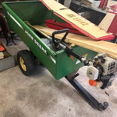 Sale Photo Thumbnail #20: Green John Deere 15 pull-behind utility cart filled with model airplane parts and power tools.