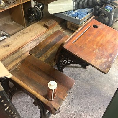 Sale Photo Thumbnail #19: Vintage school desks featuring cast iron bases and wooden tops.
