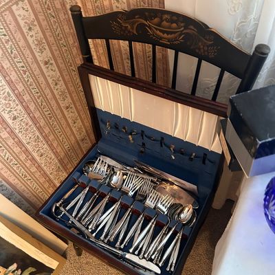 Sale Photo Thumbnail #125: Vintage flatware set presented in a stenciled wooden silverware caddy chair.