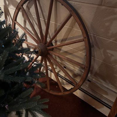 Sale Photo Thumbnail #51: Vintage spoked wooden wagon wheel with a metal rim, ideal for rustic decor.