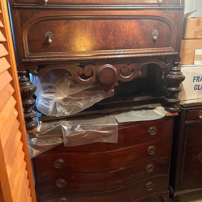 Sale Photo Thumbnail #61: Antique mahogany server or sideboard featuring carved apron detail, turned legs, ornate metal hardware, and a serpentine-front chest.