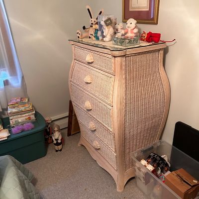 Sale Photo Thumbnail #94: White wicker tall dresser featuring a curved silhouette and seashell drawer handles.