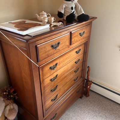 Sale Photo Thumbnail #102: Traditional wooden tallboy chest of drawers featuring batwing brass drawer pulls.