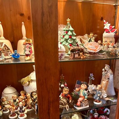 Sale Photo Thumbnail #117: Collection of vintage porcelain and ceramic figurines, featuring Goebel Hummel pieces, Christmas decorations, decorative bells, and various knick-knacks.