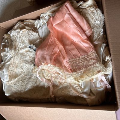 Sale Photo Thumbnail #84: Collection of vintage satin and lace lingerie, including a peach bonnet-style nightcap and ivory slips.