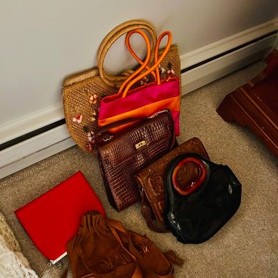 Sale Photo Thumbnail #83: Collection of vintage women's handbags, including a woven straw tote, a faux-croc satchel, a suede fringe pouch, and various leather and fabric purses.