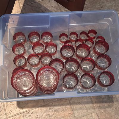Sale Photo Thumbnail #12: Large collection of vintage clear glassware featuring ruby red rims.