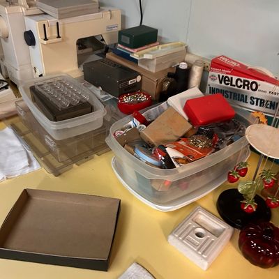 Sale Photo Thumbnail #40: Collection of sewing supplies, including a Husqvarna sewing machine, clear plastic storage bins filled with notions, thread, and decorative items.
