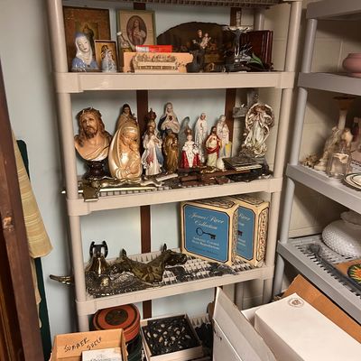 Sale Photo Thumbnail #48: Collection of religious figurines, framed icons, and brass decorative items, including James River Collection pieces.