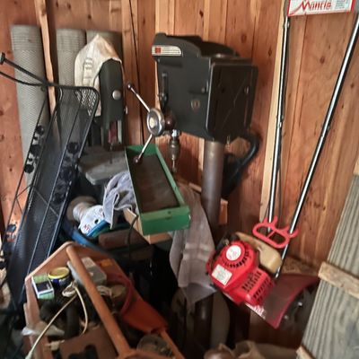 Sale Photo Thumbnail #23: Vintage floor-standing drill press alongside a Mantis gas-powered tiller, wooden caddy, and assorted workshop tools.