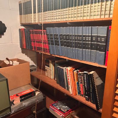 Sale Photo Thumbnail #62: Collection of vintage reference books and encyclopedia sets, including World Book Encyclopedias and annual yearbooks.