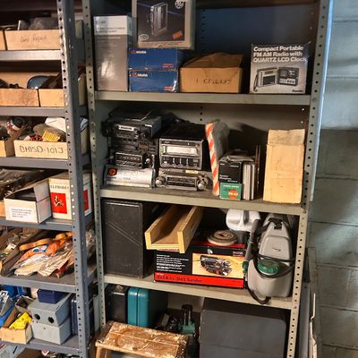 Sale Photo Thumbnail #32: Collection of vintage electronics, car stereos, power tools including a belt sander, and various hardware accessories.