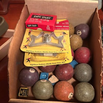 Sale Photo Thumbnail #71: Vintage billiard supply lot featuring assorted numbered pool balls, cue chalk, a Sure-Shot cue tips box, and packaged bridge heads.
