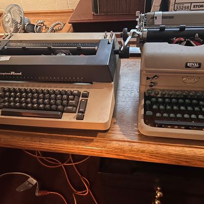 Sale Photo Thumbnail #59: Vintage Remington Rand electric typewriter alongside a vintage Royal manual typewriter.