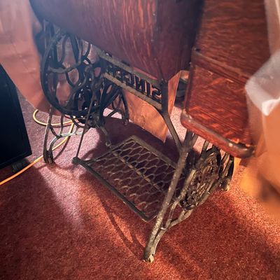 Sale Photo Thumbnail #58: Antique Singer treadle sewing machine cabinet with cast iron base and foot pedal.