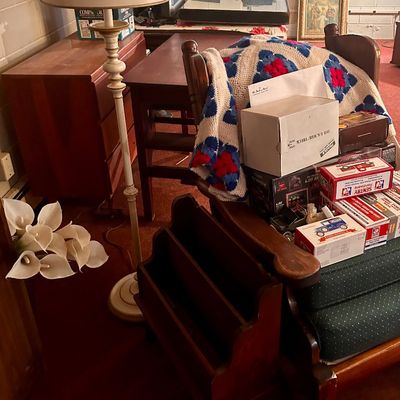 Sale Photo Thumbnail #42: Vintage floor lamp, wooden furniture, and various collectibles including boxed model cars and an afghan blanket.