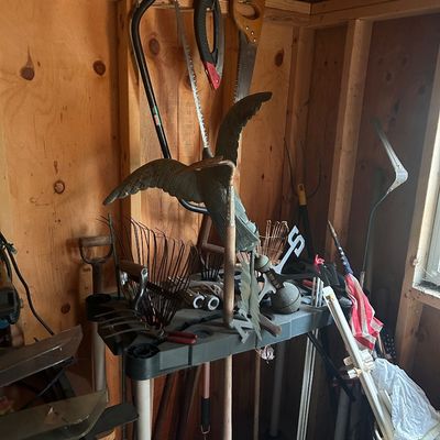 Sale Photo Thumbnail #143: Collection of lawn care equipment, hand saws, yard tools, and a metal bird sculpture weather vane.