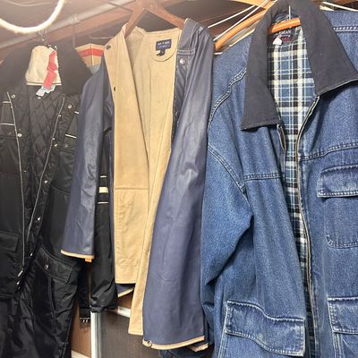 Sale Photo Thumbnail #5: Collection of men's outerwear featuring a flannel-lined denim jacket, a Van Heusen hooded jacket, and a black winter snow suit.