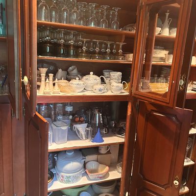 Sale Photo Thumbnail #14: Large wooden cabinet filled with glassware, stemware, tea sets, and various kitchen items.