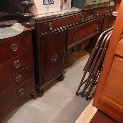 Sale Photo Thumbnail #67: Traditional dark wood sideboard buffet with decorative brass hardware and carved apron detailing, paired with a matching chest of drawers.