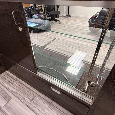 Sale Photo Thumbnail #431: This modular unit consists of a desk with a drawer and shelves, and a glass display counter with internal glass shelving and two drawers. It has a Formica style finish. There is age related wear. Contents are not included. Measurement: 73” x 84.5” (di