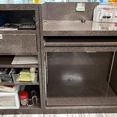 Sale Photo Thumbnail #430: This modular unit consists of a desk with a drawer and shelves, and a glass display counter with internal glass shelving and two drawers. It has a Formica style finish. There is age related wear. Contents are not included. Measurement: 73” x 84.5” (di