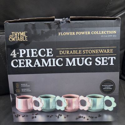 Sale Photo Thumbnail #57: A 4-piece durable stoneware ceramic mug set by Thyme & Table from the Flower Power Collection. Mugs feature flower-shaped handles and an iridescent pearl finish. Capacity is 13.5 oz (399 mL) per mug. Item appears new in original retail box.