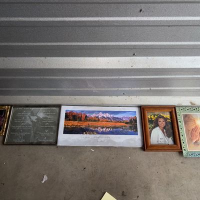 Sale Photo Thumbnail #86: Collection of five framed pictures and wall prints including a religious Ten Commandments print, a panoramic Grand Teton National Park print, a wooden picture frame with portrait, a decorative ornate green framed praying hands print, and a small gold-tone