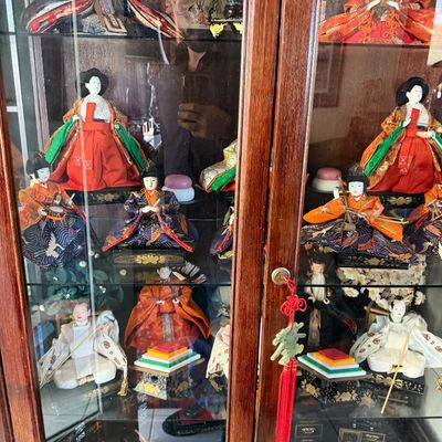 Sale Photo Thumbnail #5: Traditional Japanese Hina Matsuri doll set displayed inside a wooden curio cabinet with glass shelves.