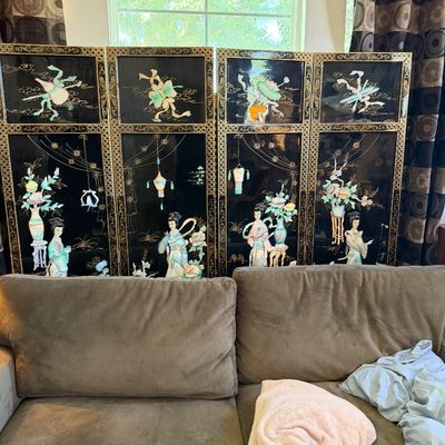 Sale Photo Thumbnail #22: Four-panel vintage Asian black lacquer room divider screen featuring carved mother-of-pearl and stone figures and floral motifs, displayed behind a brown sofa.