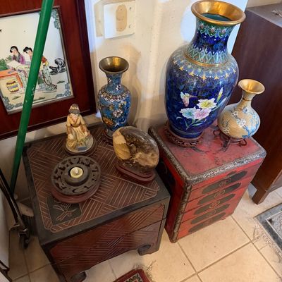 Sale Photo Thumbnail #28: Collection of Asian decorative items, featuring cloisonné brass vases, a carved stone piece on a stand, a small ceramic figurine, and a red painted mini chest.