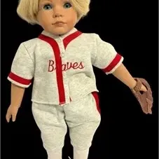 Blonde collector doll dressed in a grey and red Braves baseball uniform, complete with miniature baseball mitt and red sneakers.