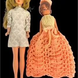 Pair of vintage fashion dolls, including a blond doll in a white patterned mini dress and a smaller doll in a hand-crocheted peach ballgown.