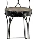 Vintage wrought iron sweet shop bar stool featuring a heart-shaped backrest, round seat, and twisted wire legs.