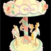 Vintage musical carousel figurine featuring pastel horses, floral details, and a striped center pole.