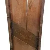 Antique wooden cabbage slicer or kraut cutter with metal trim and diagonal blade, showing age-appropriate wear and patina.