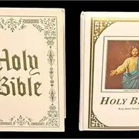 Pair of vintage hardbound Holy Bibles featuring white covers with ornate gold-tone embossed detailing and illustrations.