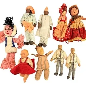 Collection of nine vintage folk art and souvenir dolls in various traditional and novelty attire.