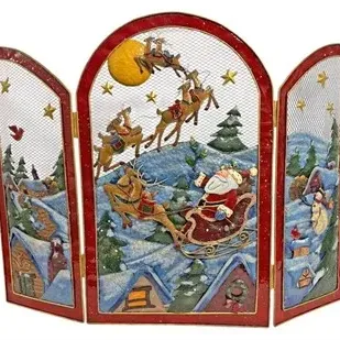 Three-panel painted metal mesh Christmas fireplace screen featuring Santa Claus and his reindeer flying over a snowy village.