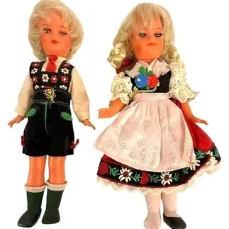 Pair of vintage blonde souvenir dolls dressed in traditional European folk attire, including lederhosen and a dirndl.