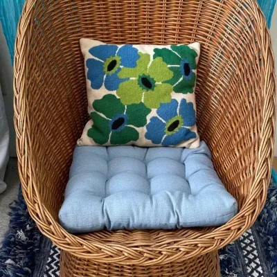 Mod brown wicker chair with cushion and pillow