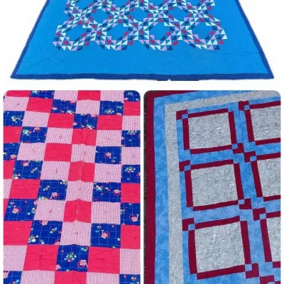 Trio of handmade red and blue quilts