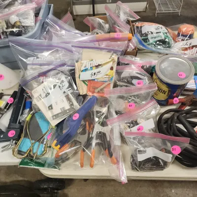 Sale Photo Thumbnail #137: Assorted workshop tools, hardware, and fasteners organized in plastic zip-top bags with pink price stickers.
