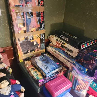 Collection of vintage board games, puzzles, craft sets, and a boxed Lionel train set.