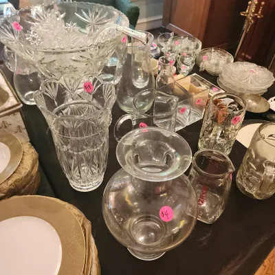 Sale Photo Thumbnail #110: Collection of assorted clear cut glass and plain glassware, including a large punch bowl set, vases, pitchers, and beer mugs.
