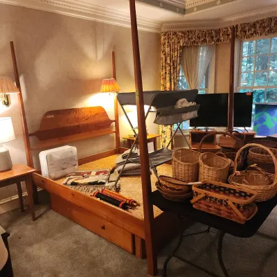 Shaker-style queen wooden four-poster bed frame.